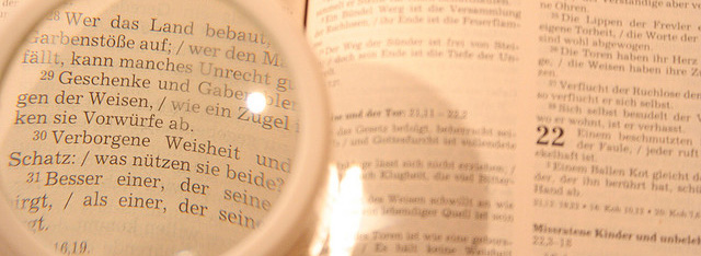 Picture of magnifying glass over a book