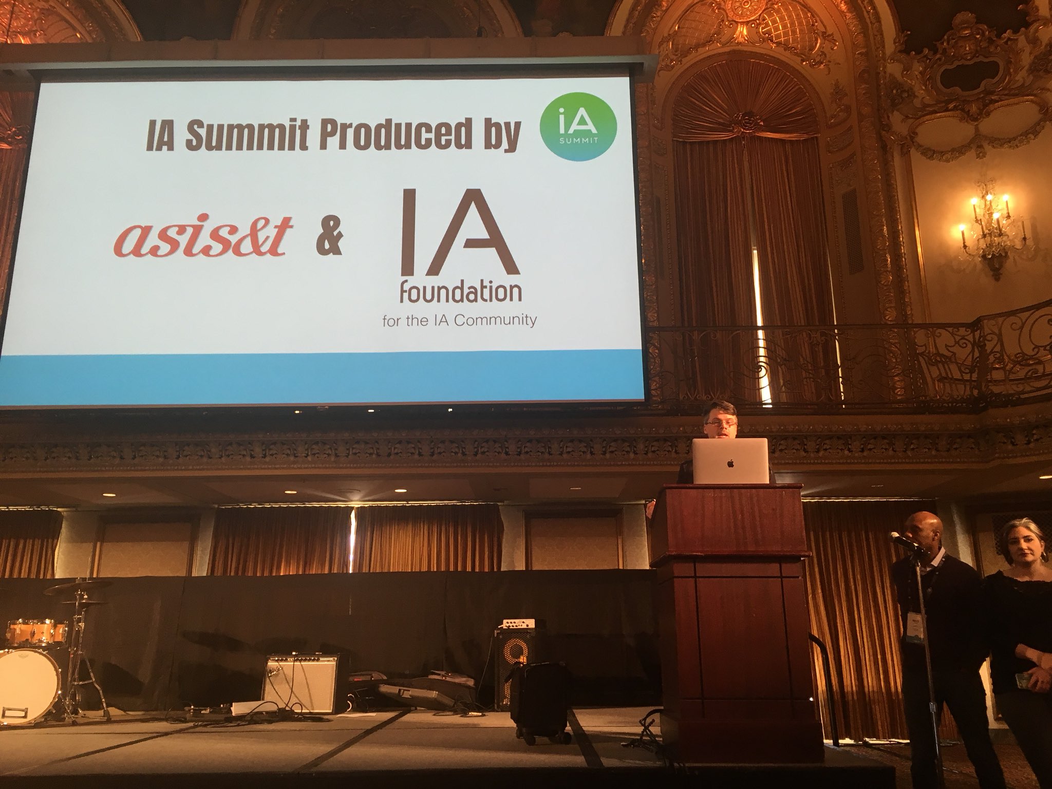 IA Summit co-chair on stage opening the conference.
