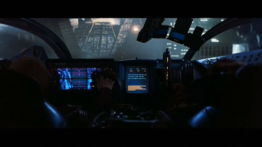 The view looking out from the cabin of a futuristic vehicle shows multiple dashboards.