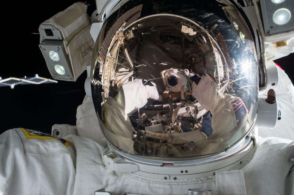 reflective-visor-of-astronaut-working-in-space