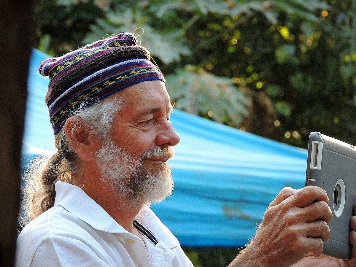 Older man using an iPad to take a photo